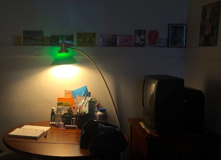 This photograph shows the author's tube television, along with the same green lamp casting a warm glow
